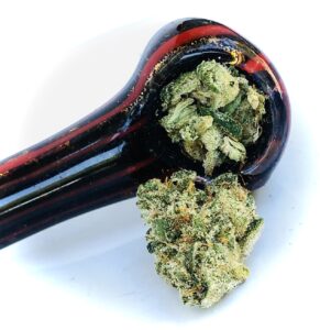 closeup of soul safari with glass bowl packed and bud next to pipe