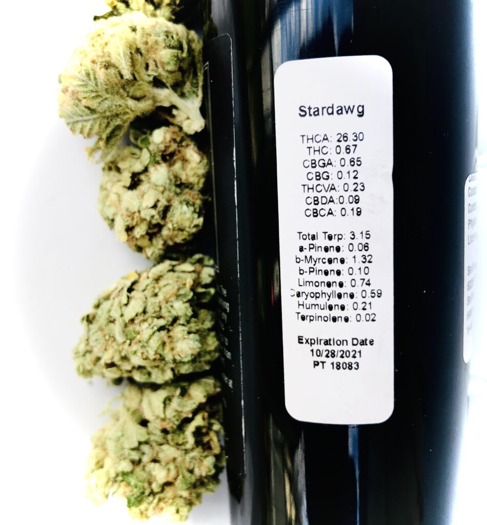 buds of stardawg by hms next to terpene label on bottle