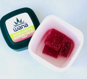 wana sour chews in bottle with wana label on cap next to contaner