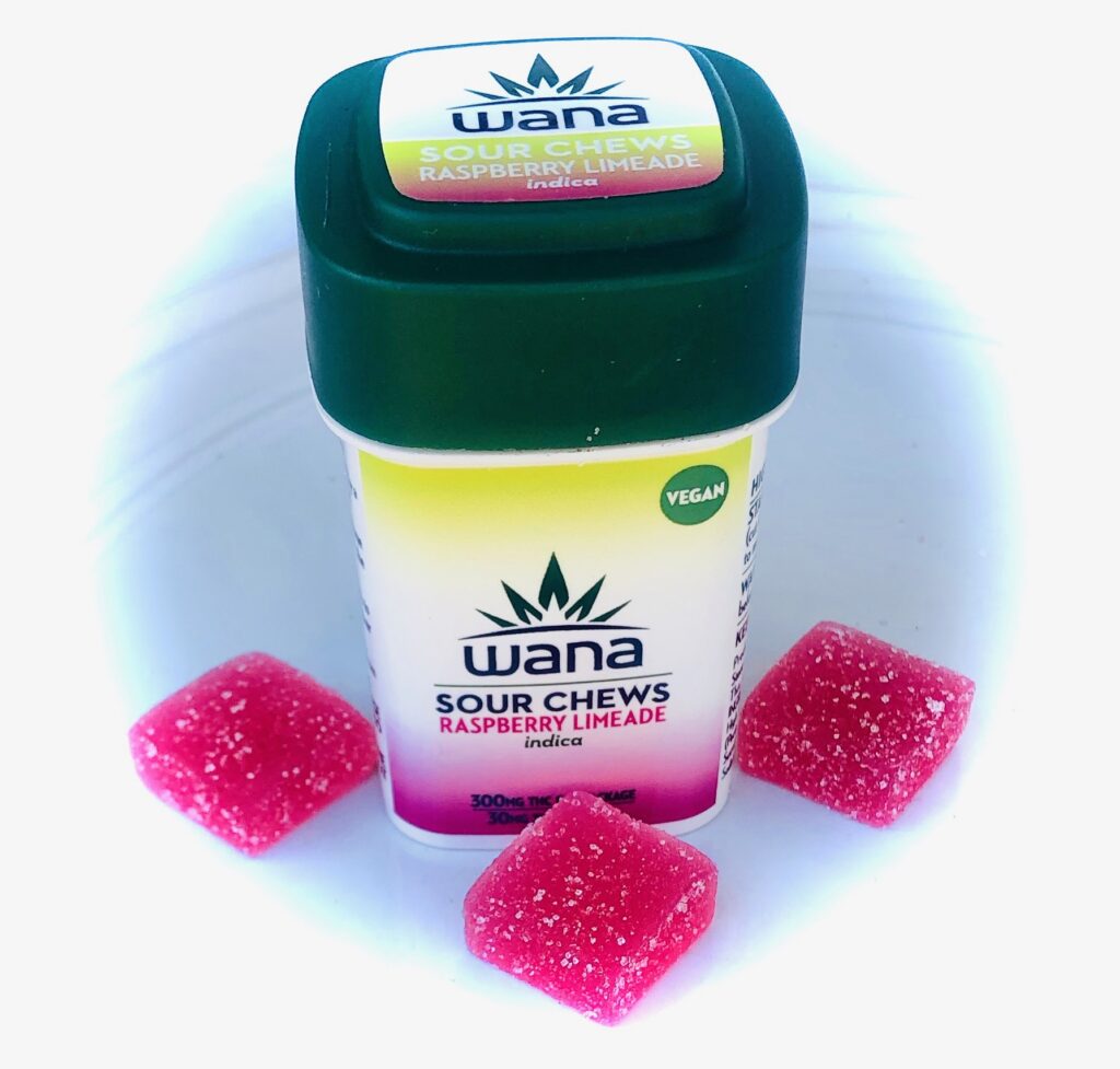 wana sour chews postioned around wana bottle with green top and yellow and raspberry colored label with word wana in green