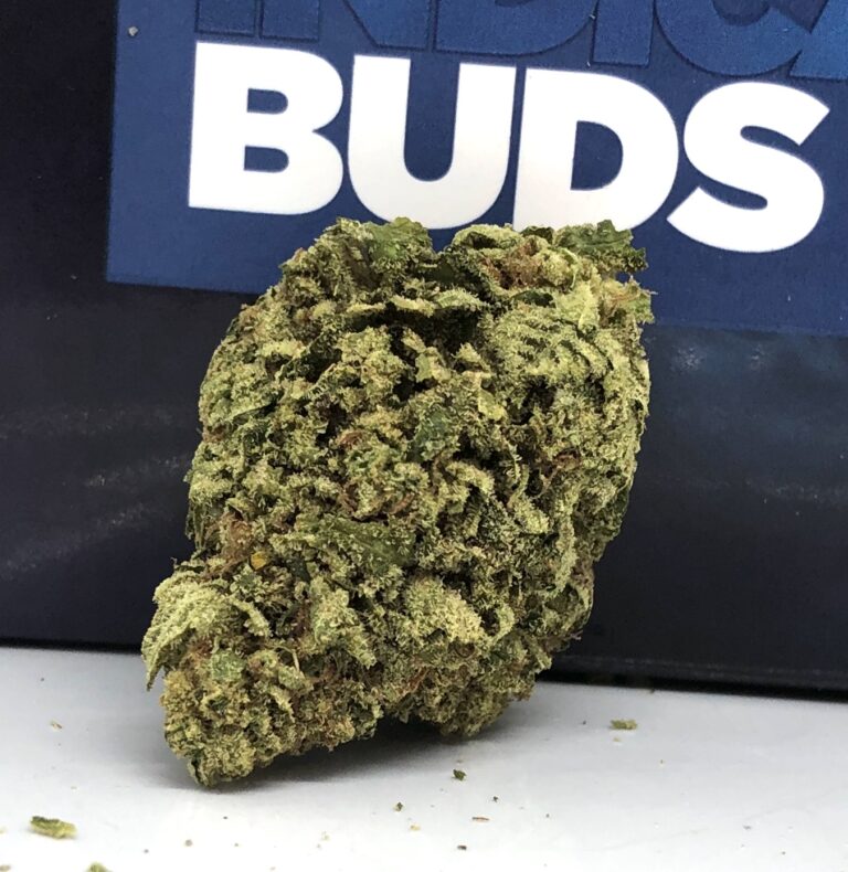 alternate view of large element strain nug in front of dark blue modern flower package with the word Buds written in large white print