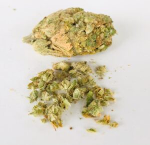 an untouched bud of lemon kush headband compared a bud that has been broken apart
